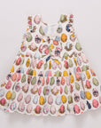 Children's dress with colorful pattern on a light gray background