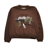 Brown sweatshirt with a graphic of a wolf and mountains on a white background