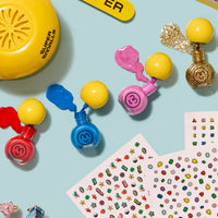 Colorful stampers and sticker sheets on a light blue background with 'Super' text.