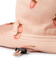 Pink bucket hat with strawberry pattern on a white background