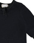 Black sweater with a brand label on a white background