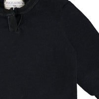 Black sweater with a brand label on a white background