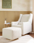 White armchair with ottoman in a modern living room setting