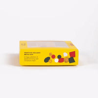 Yellow box of festive holiday bead mix on a white background