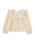 A baby girl's long-sleeve blouse with a delicate, all-over floral print in soft pink and green on a warm cream background. The top features ruffled shoulder details, a smocked waist, and a small fabric flower embellishment on the right shoulder.
