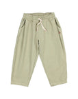 A pair of light sage green children's jogger pants with an elastic waistband, cream-colored drawstring, and side pockets, shown against a plain light gray background.