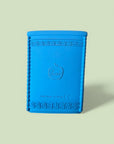 Blue textured book-shaped object with a brand logo on a light green background