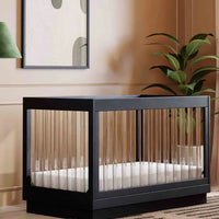 Modern crib in a stylish room with a lamp and plant