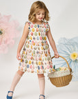 Young girl in a patterned dress holding a basket with flowers against a white background