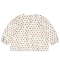 Baby blouse with floral pattern on a white background