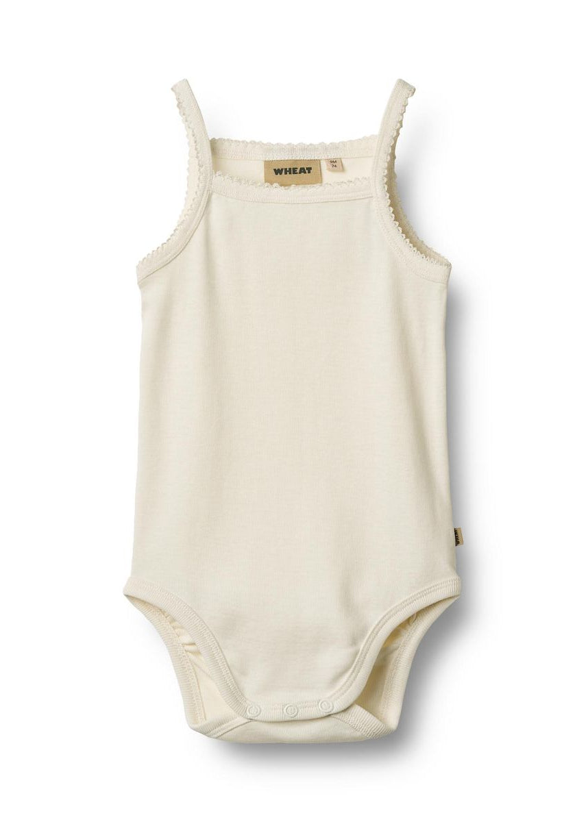 Beige baby bodysuit with thin straps on a white background