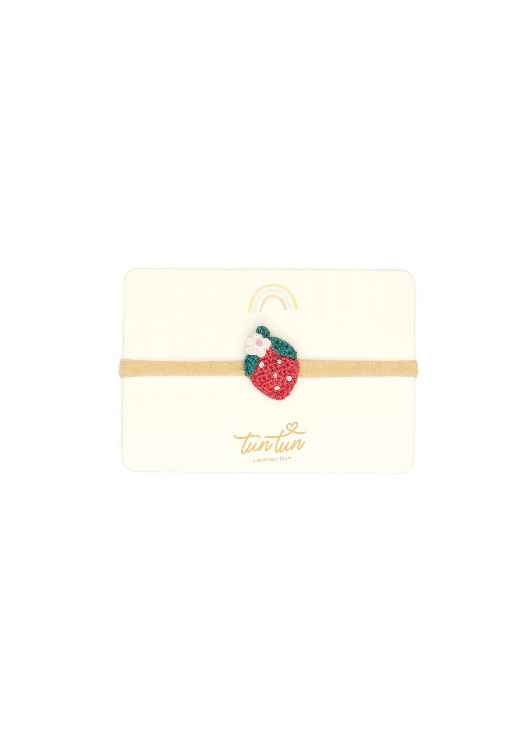 Strawberry-themed hair clip on a white background