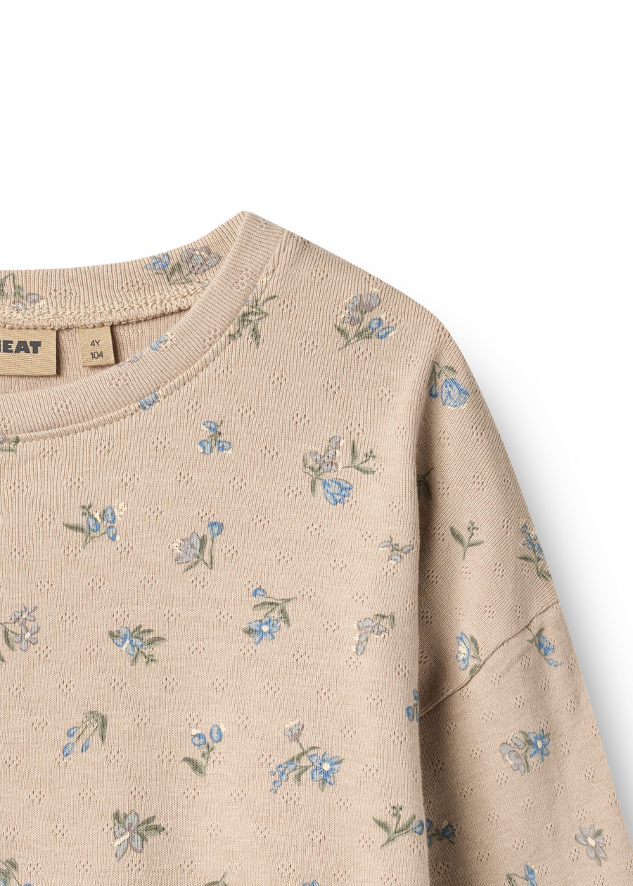 Beige sweatshirt with floral pattern on a white background