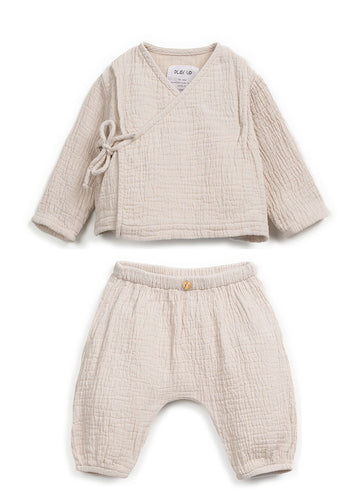 Beige baby outfit with top and pants on a white background