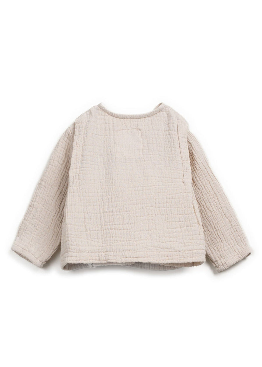 Beige textured sweater on a white background