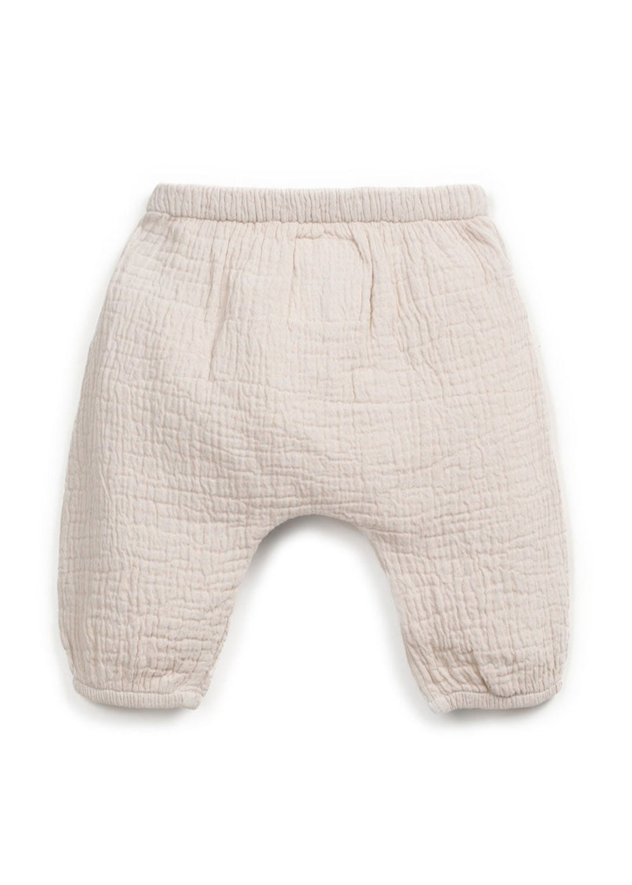Beige baby pants on a white background