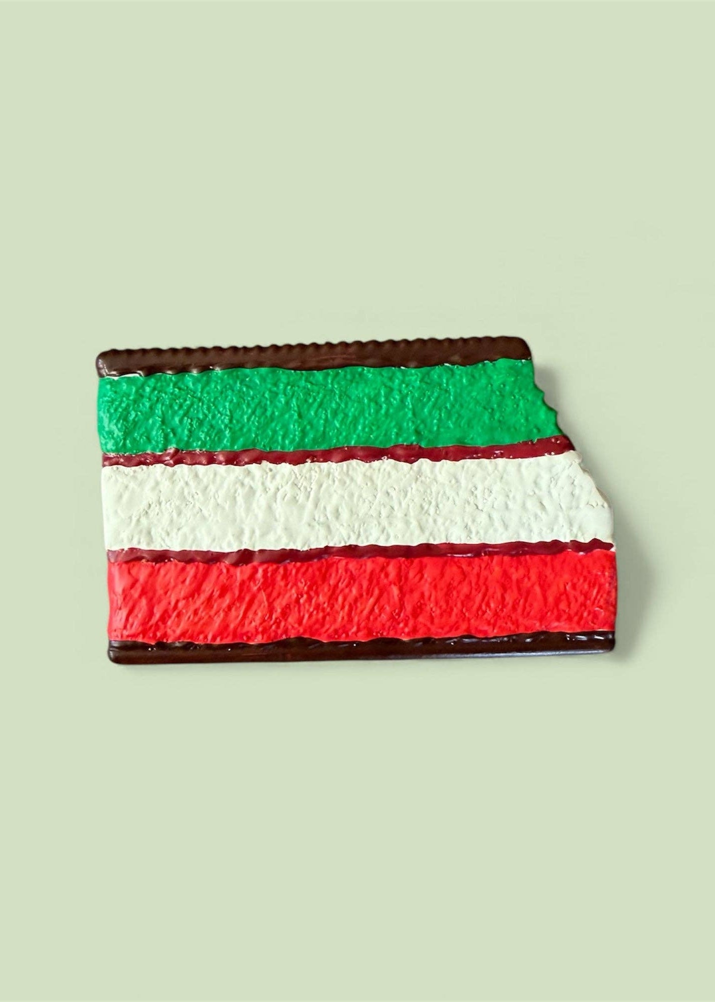Colorful layered dessert on a light green background
