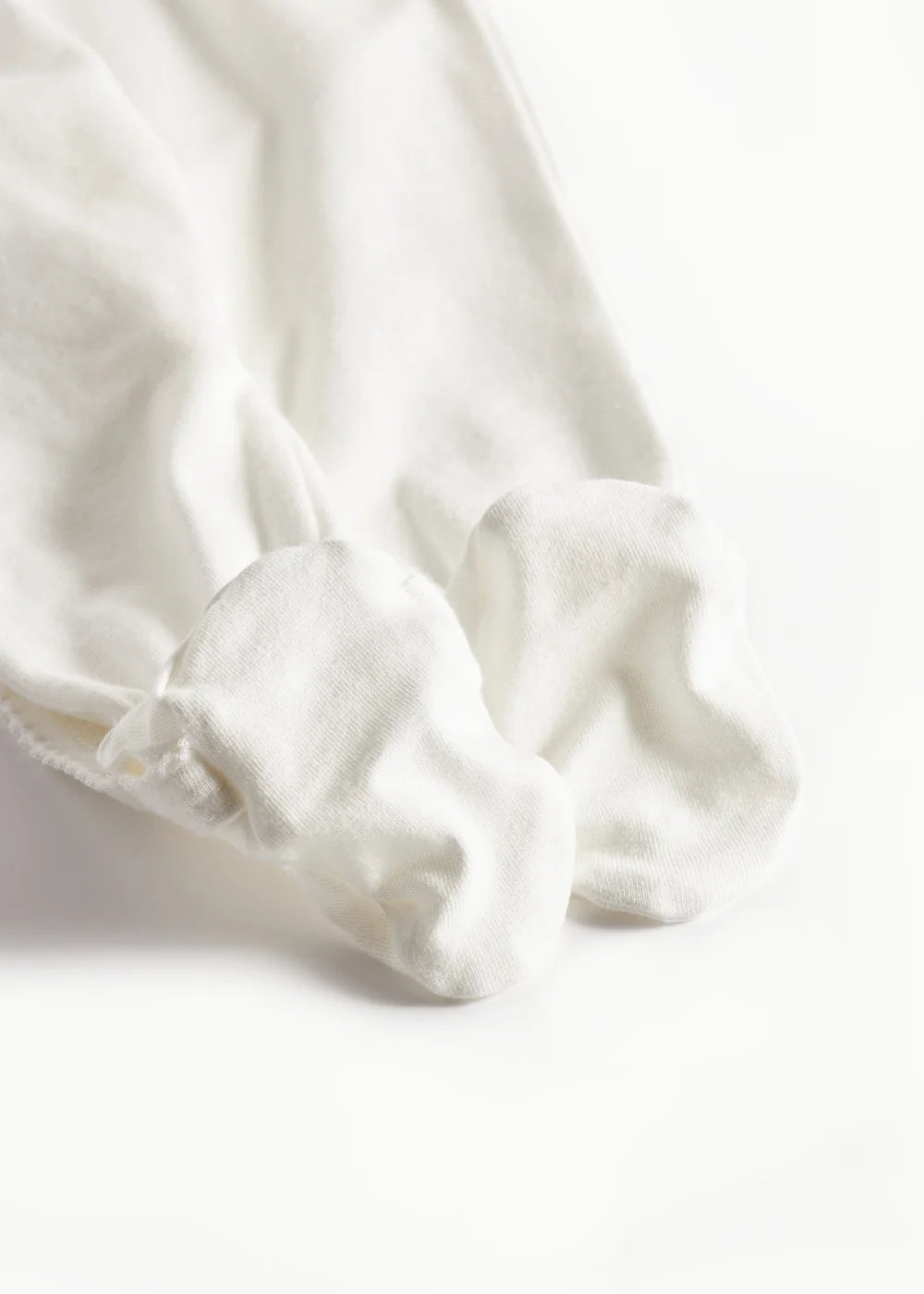 White fabric with a subtle pattern on a white background