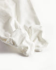 White fabric with a subtle pattern on a white background