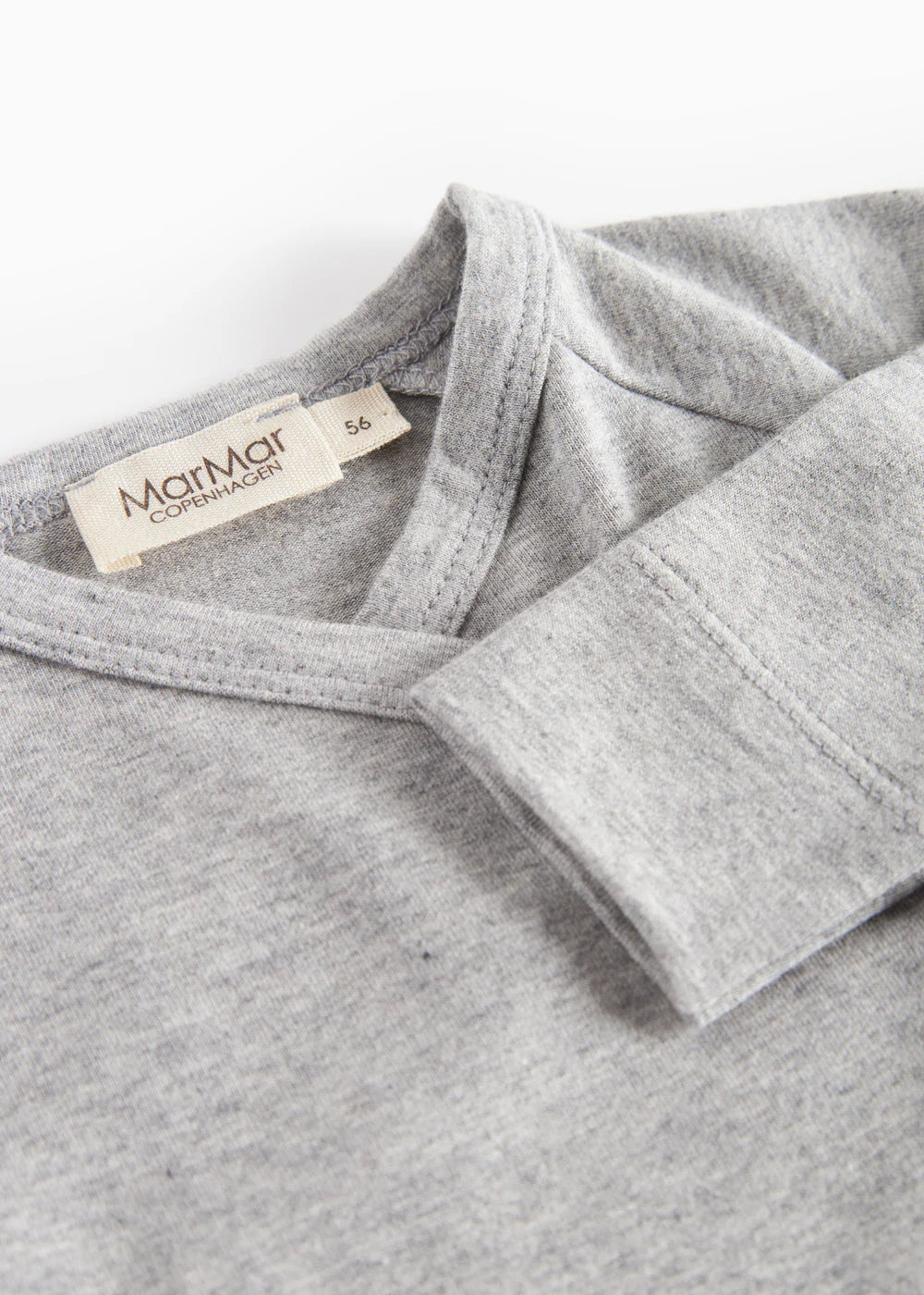 Gray fleece garment with a brand label on a white background