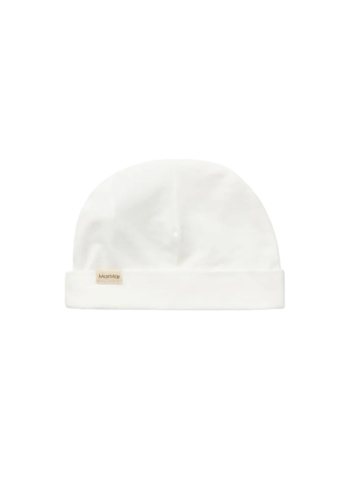 A white knit beanie hat with a folded cuff, featuring a small beige fabric brand tag on the front that reads 'MatMar'. The hat is photographed flat against a seamless white background.