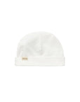 A white knit beanie hat with a folded cuff, featuring a small beige fabric brand tag on the front that reads 'MatMar'. The hat is photographed flat against a seamless white background.