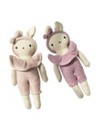 Two knitted dolls, one in beige and the other in pink, on a white background.