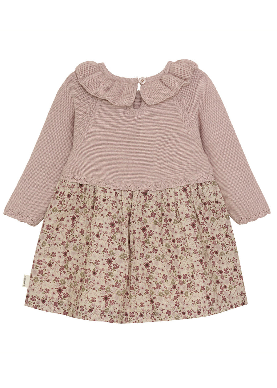 Children's dress with ribbed sweater top and floral skirt on a white background