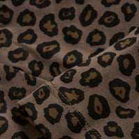 Close-up of fabric with a leopard print pattern on a beige background