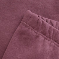 Close-up of a folded purple fabric with visible stitching