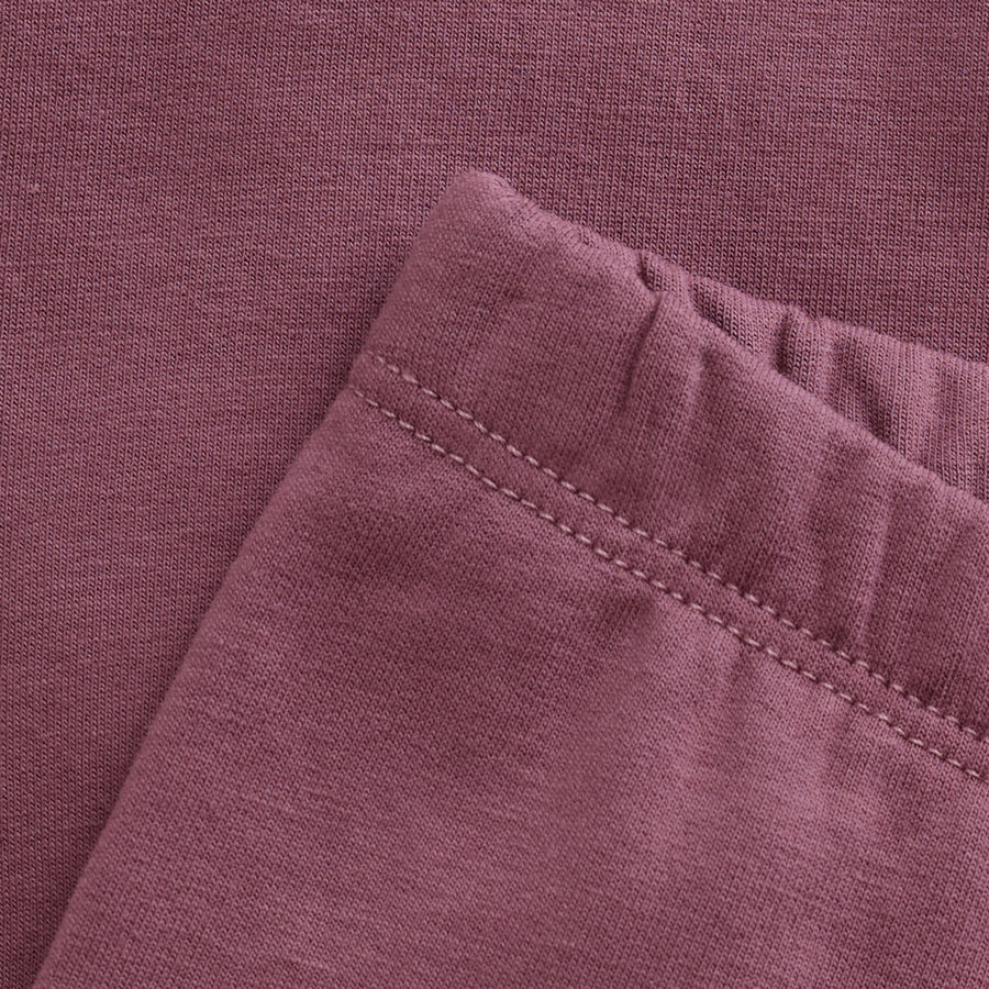 Close-up of a folded purple fabric with visible stitching