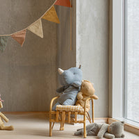 Children's room with plush toys and a round hanging decoration.