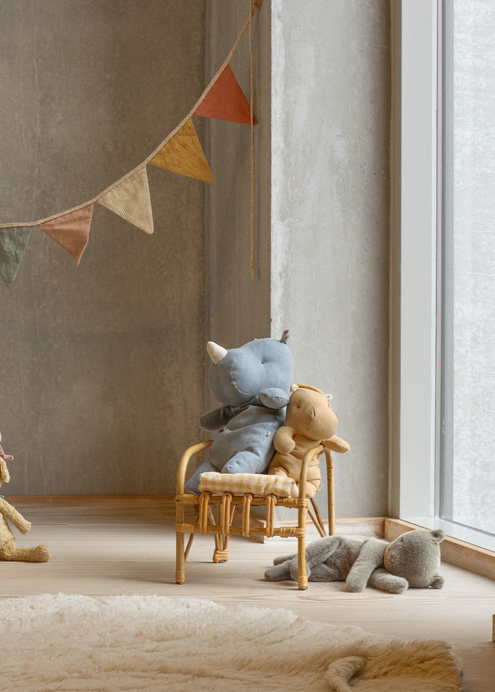 Children's room with plush toys and a round hanging decoration.