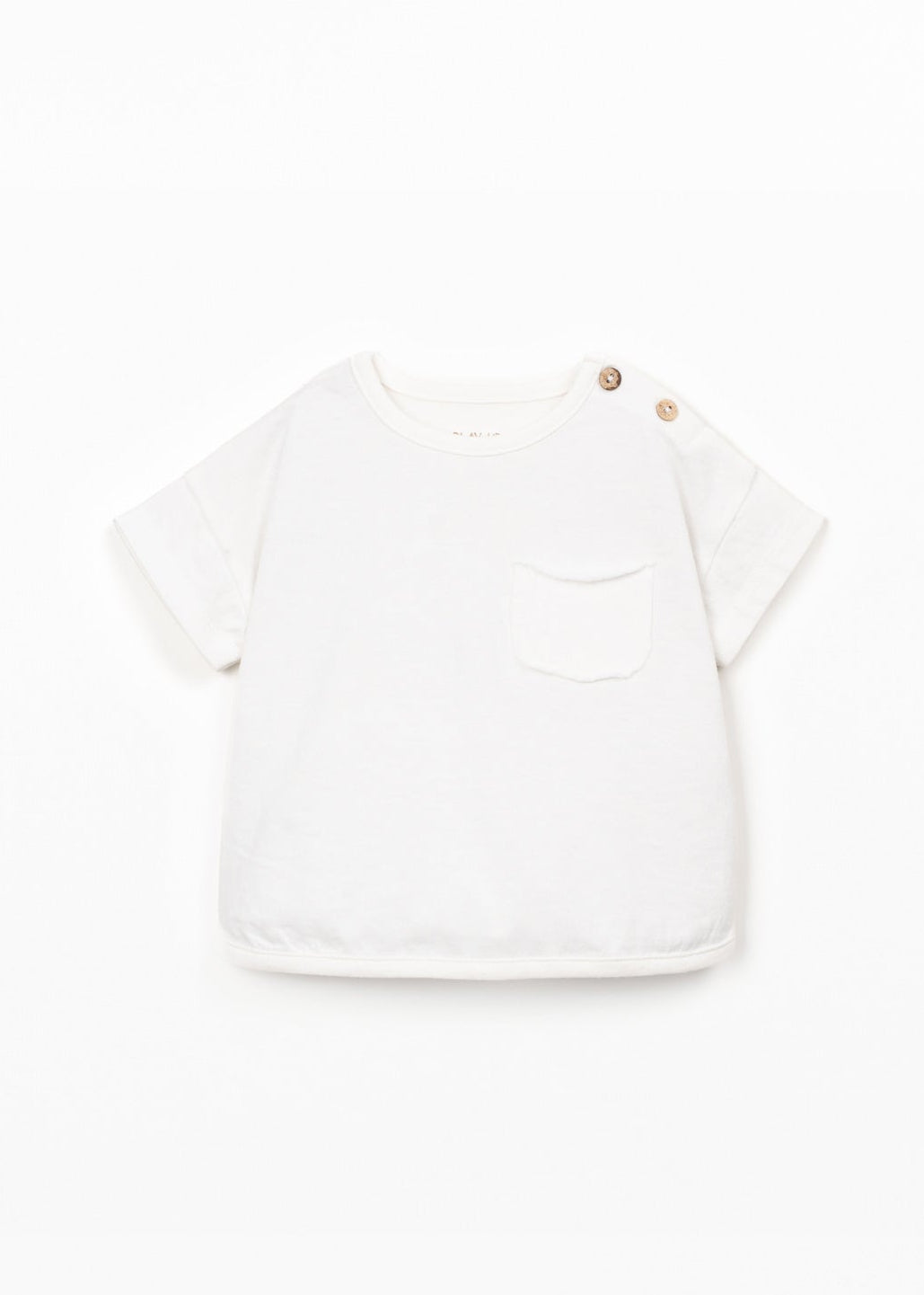 White t-shirt with a small graphic on a light beige background