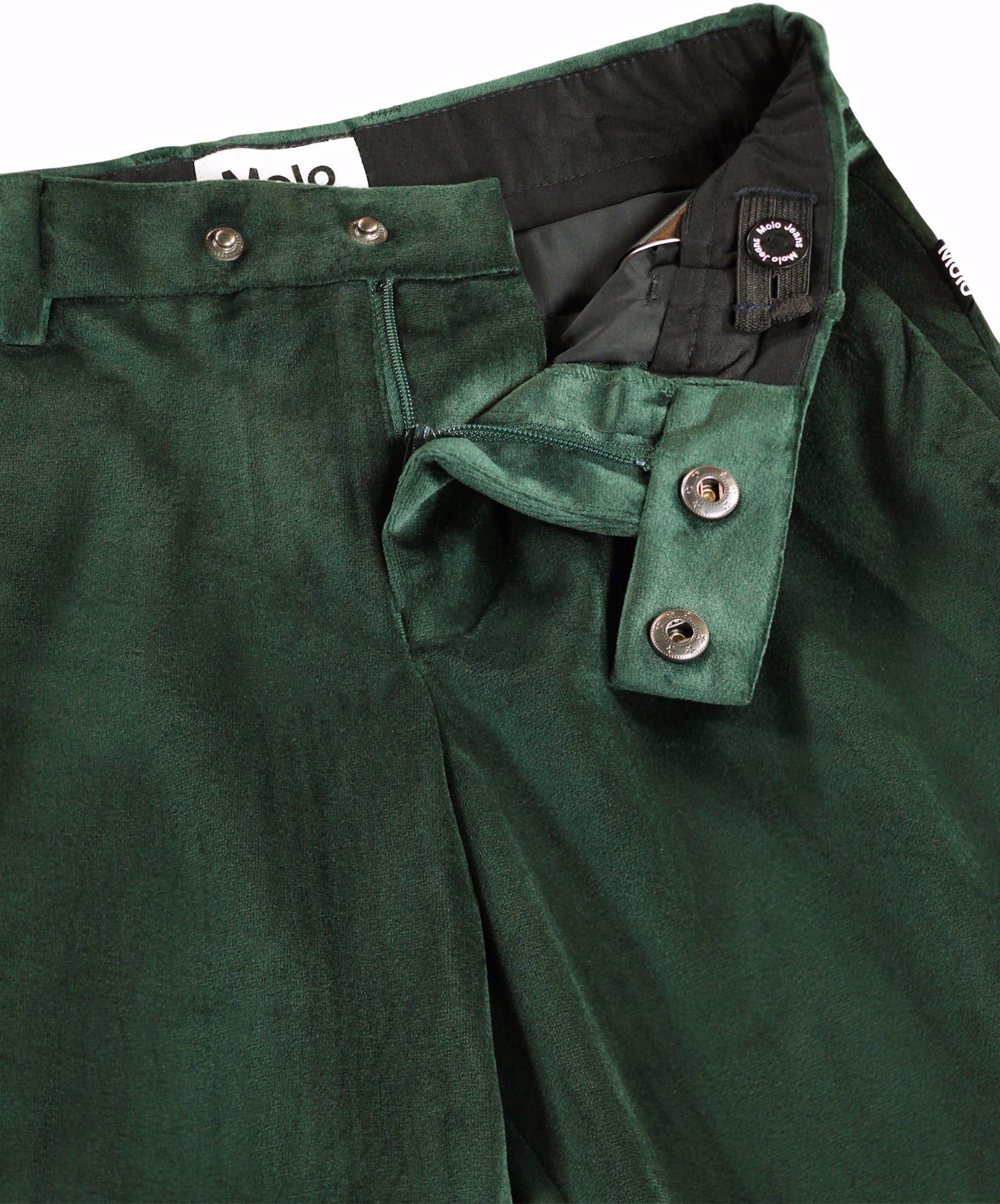 Close-up of dark green corduroy trousers showing the waistband, button details, and inner lining.
