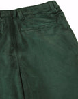 Close-up of dark green trousers showing the waistband, belt loops, and side pocket on a white background.