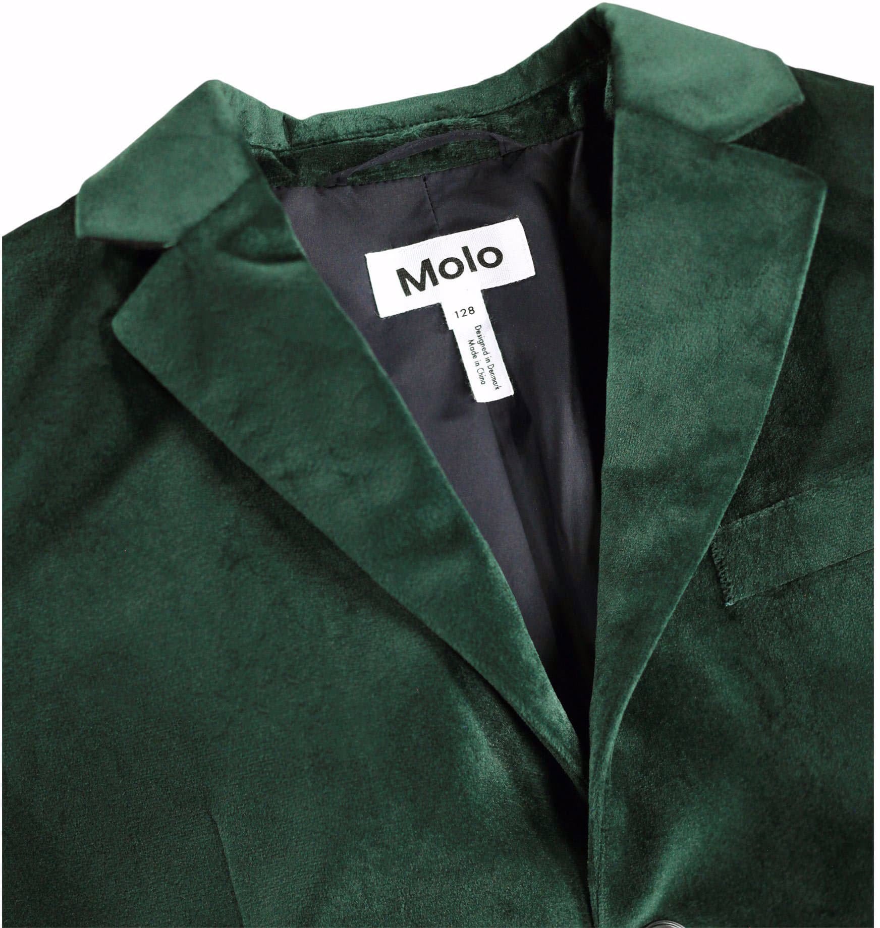 Close-up of a dark green velvet blazer jacket with a white brand label reading 'Molo' inside the collar, on a plain white background.