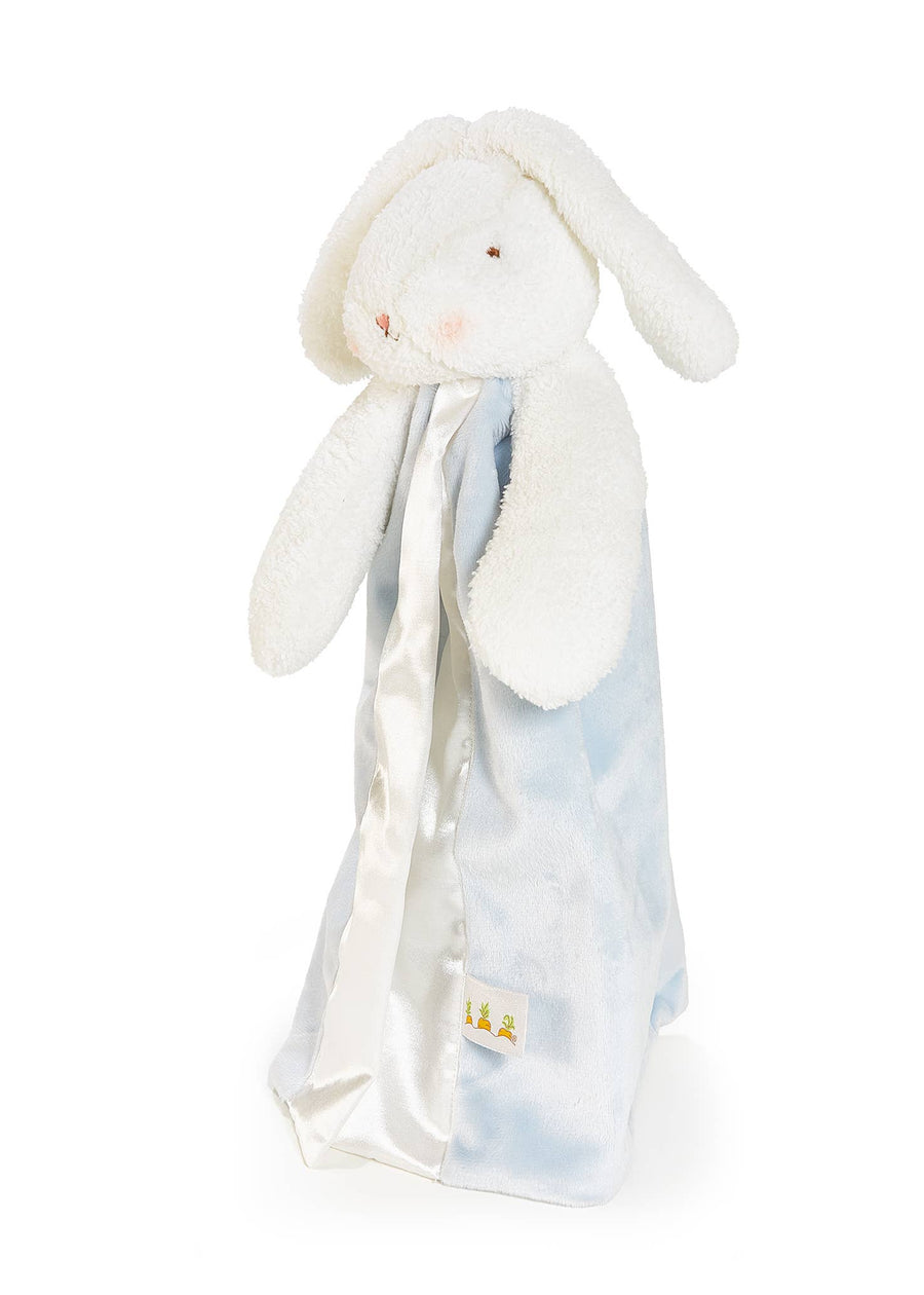 White bunny plush toy with a soft, patterned blanket draped over it on a white background