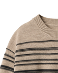 Close-up of a beige sweater with black horizontal stripes on a white background