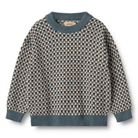 Patterned sweater with blue trim on a white background