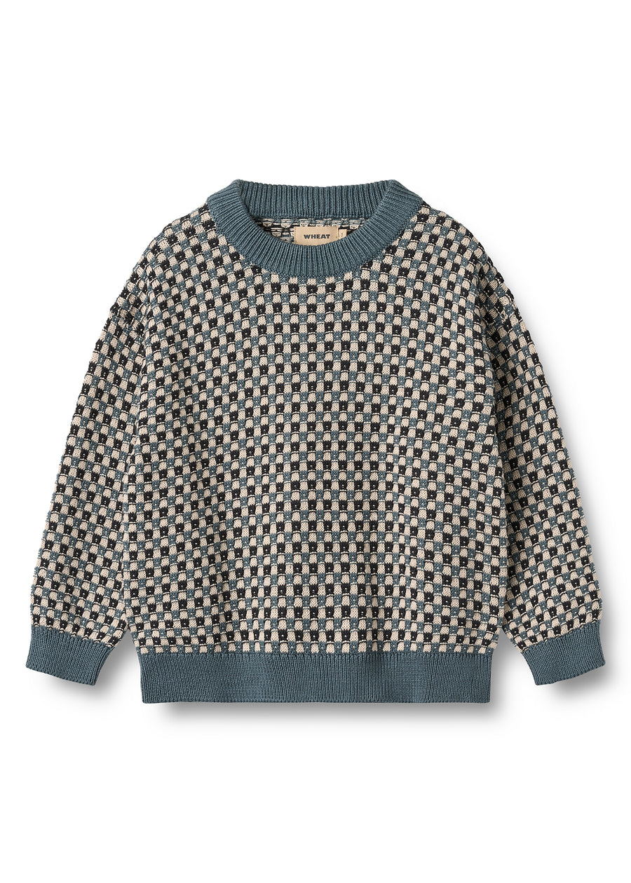 Patterned sweater with blue trim on a white background