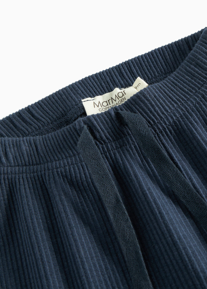 Navy blue ribbed pant with a brand label on a white background