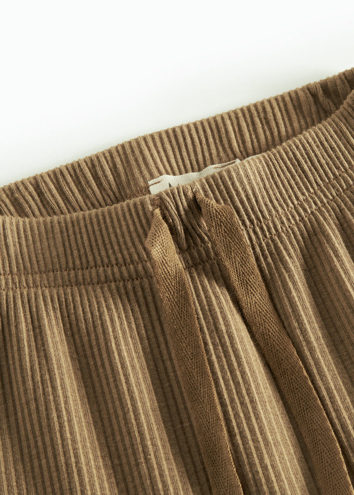 Close-up of brown pants on a white background