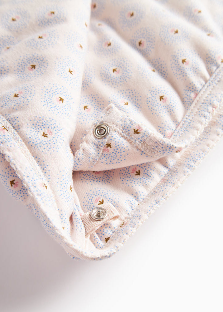 Folded fabric with small buttons on a light background
