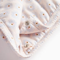 Folded fabric with small buttons on a light background