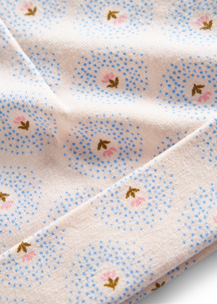 Close-up of a fabric with small floral patterns on a light background