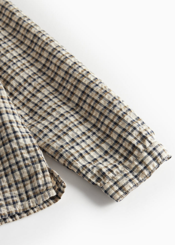Folded checkered fabric on a white background