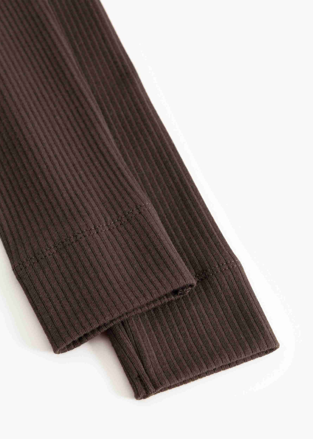 Close-up of brown ribbed sweater cuffs on a white background