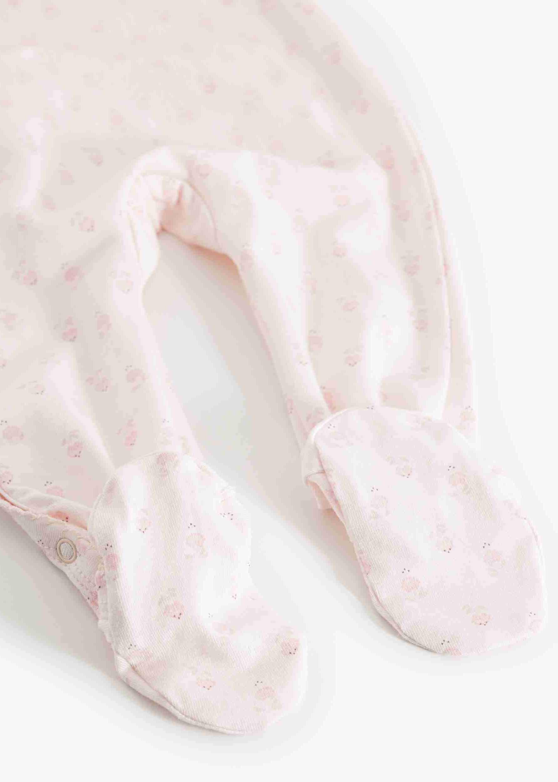 Close-up of pink baby socks with a subtle pattern on a white background