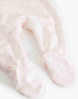 Close-up of pink baby socks with a subtle pattern on a white background